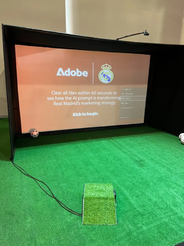 Custom soccer image reveal game screen with kick-to-begin prompt at Adobe Summit