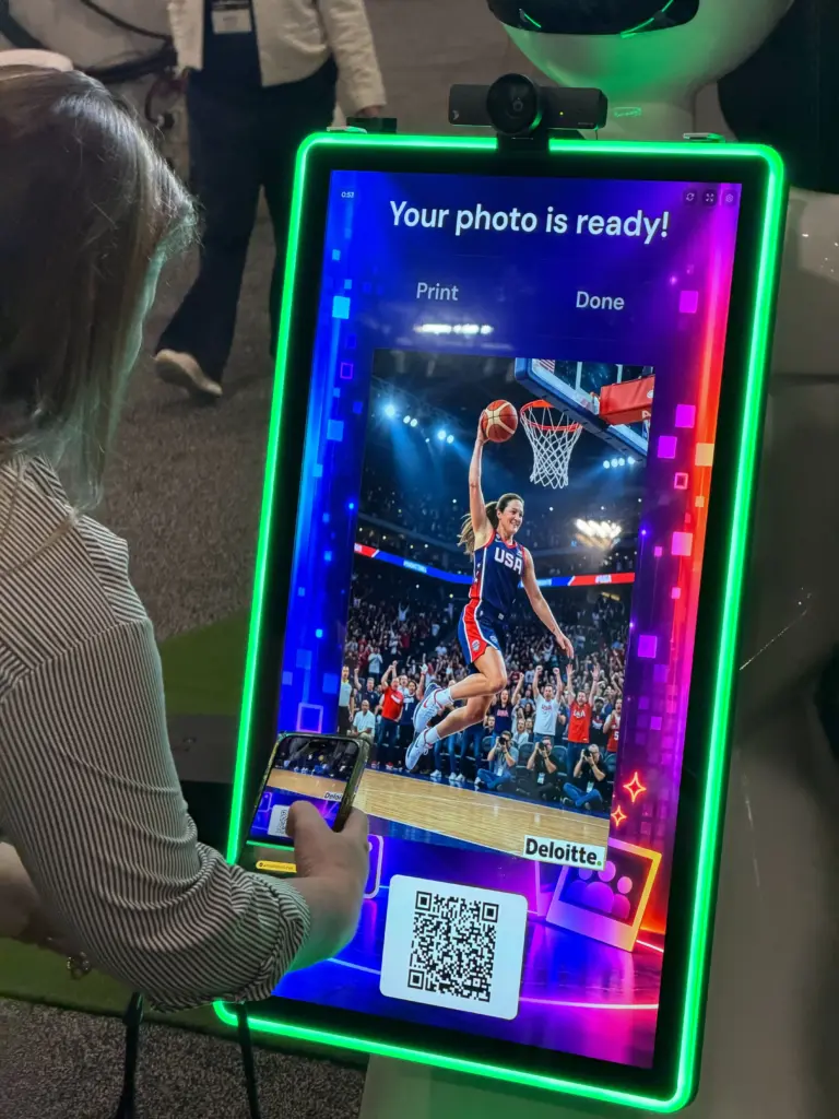 Guest scanning the QR code for a Deloitte-branded AI basketball portrait on the AI photo booth screen in Las Vegas