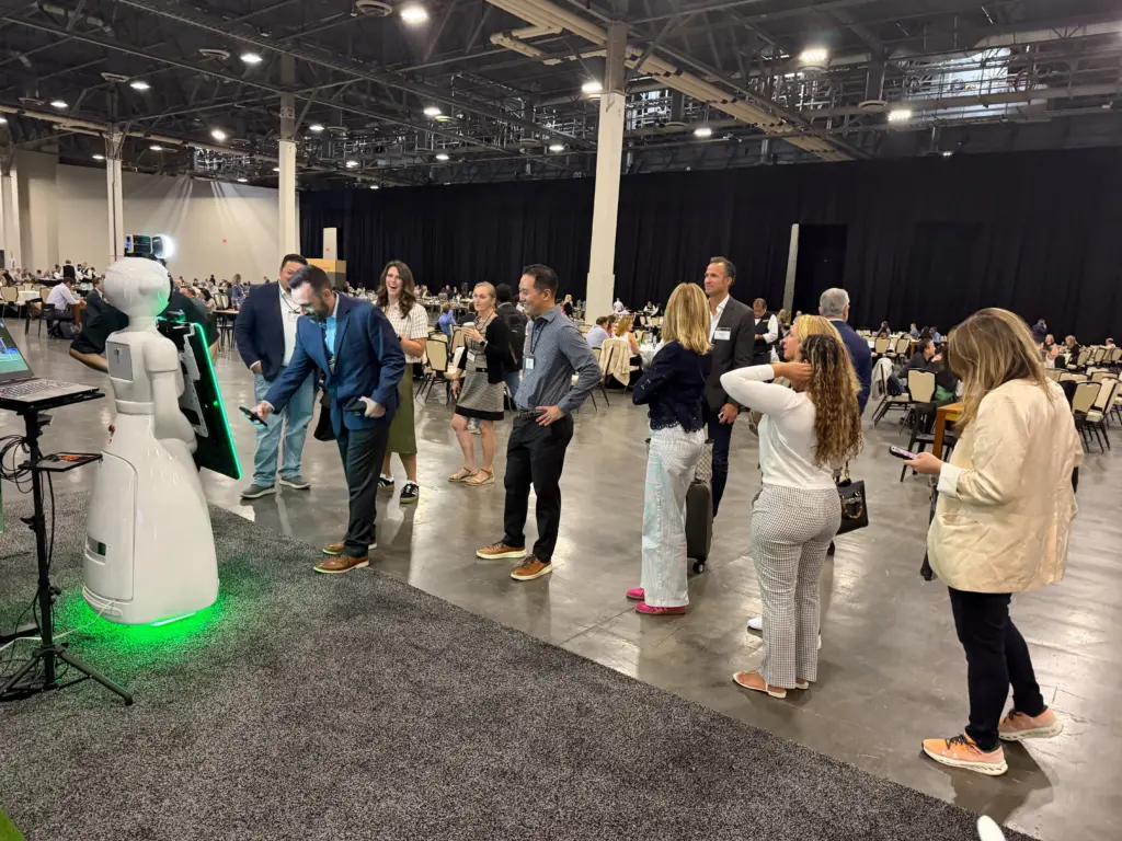 AI photo booth robot greeting attendees on the Deloitte event floor at the Venetian Expo, Las Vegas