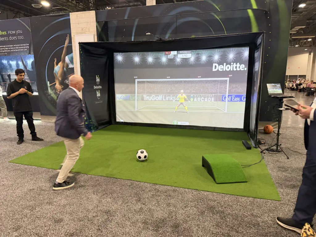 Guest stepping up to take a penalty kick on the Deloitte branded soccer simulator at the Venetian Expo, Las Vegas