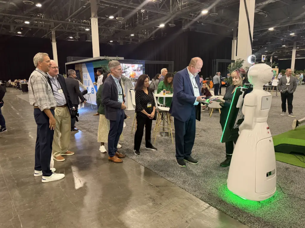 Deloitte guests lining up while our host helps a guest at the AI photo booth robot at the Venetian Expo, Las Vegas