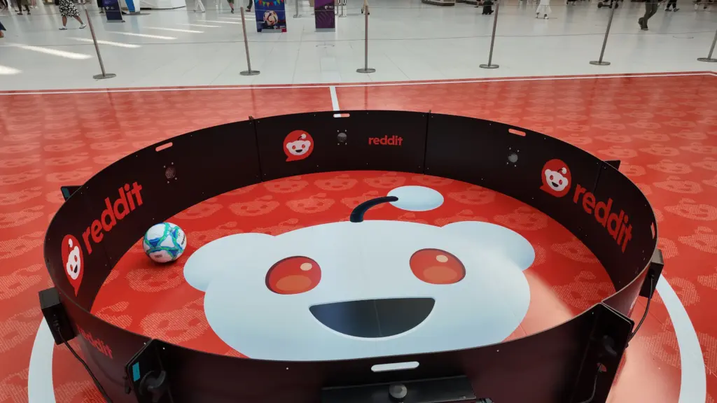 Close view of the Reddit-branded soccer reaction ring with the Snoo floor graphic and a ball inside, Oculus, New York