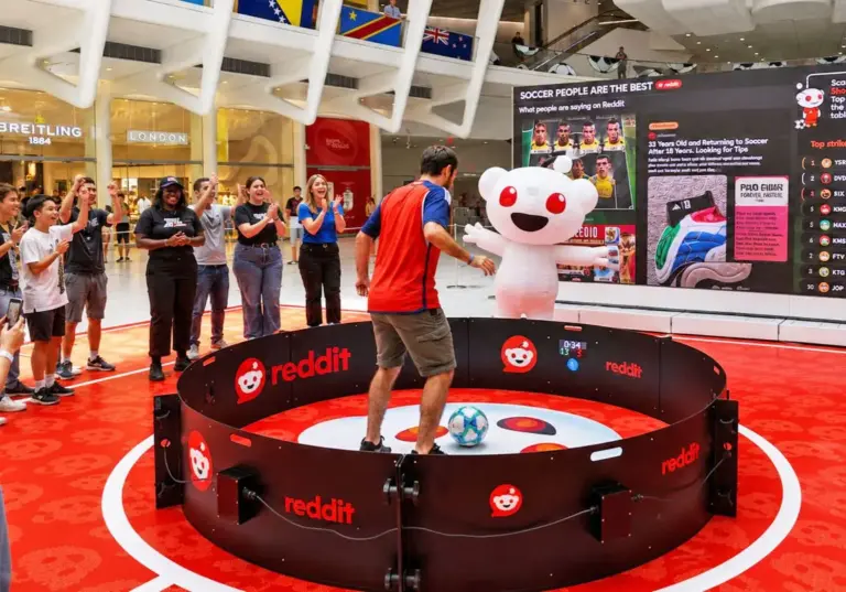 Crowd watching a player inside a soccer reaction ring rental at a branded trade show activation