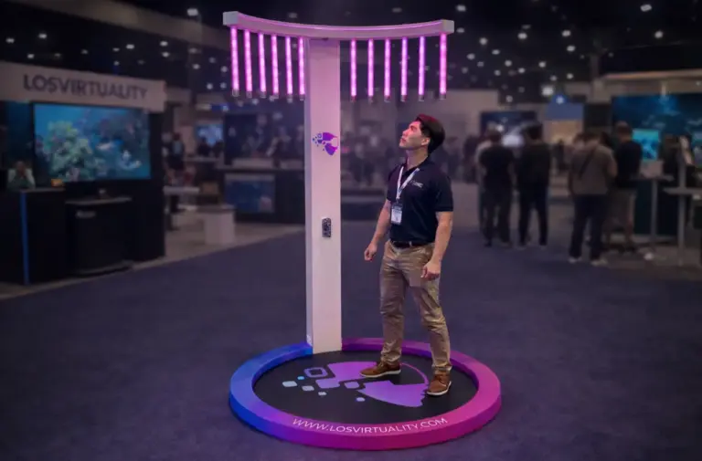 Player reaching for falling light sticks in a Catch the Stick game rental at a trade show
