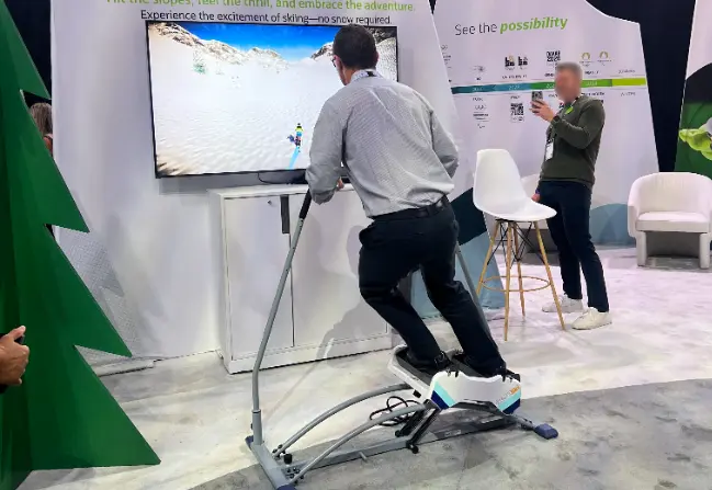Guest balancing on a ski simulator rental with a snowy slope on screen